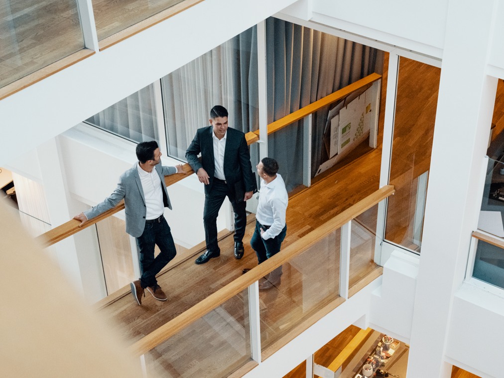 Collagues talking in office environment.